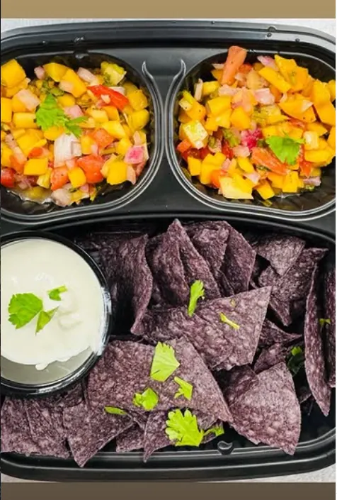 Fresh mango salsa with blue organic corn chips and crema