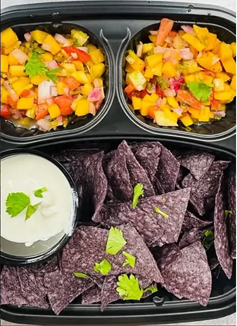 Fresh mango salsa with blue organic corn chips and crema